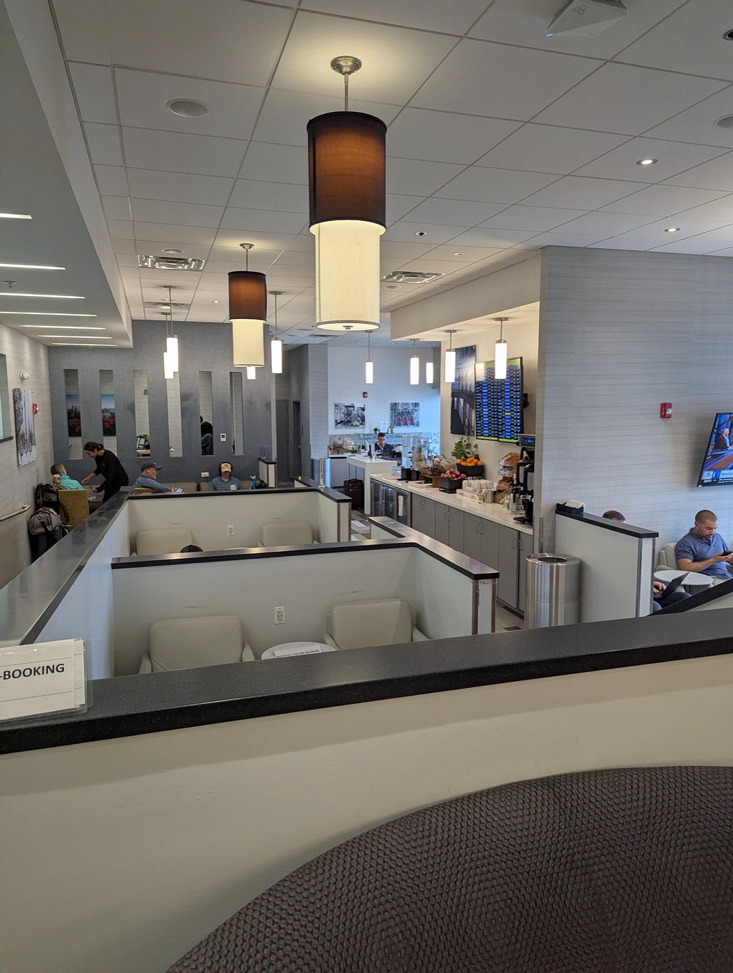 Seating area and a snack and drinks counter inside a Club airport lounge